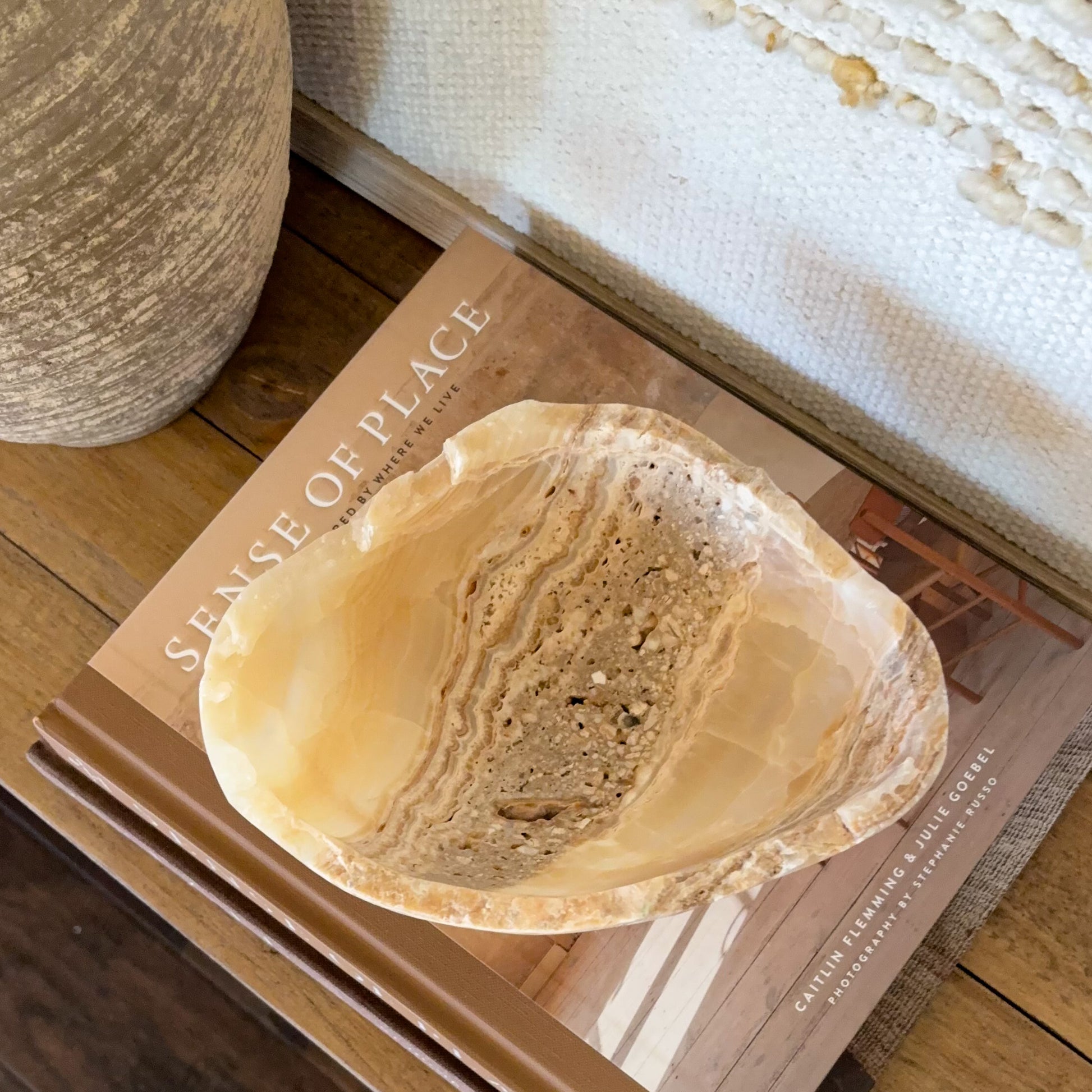 Polished small onyx crystal bowl in amber tones for decorative tabletop display