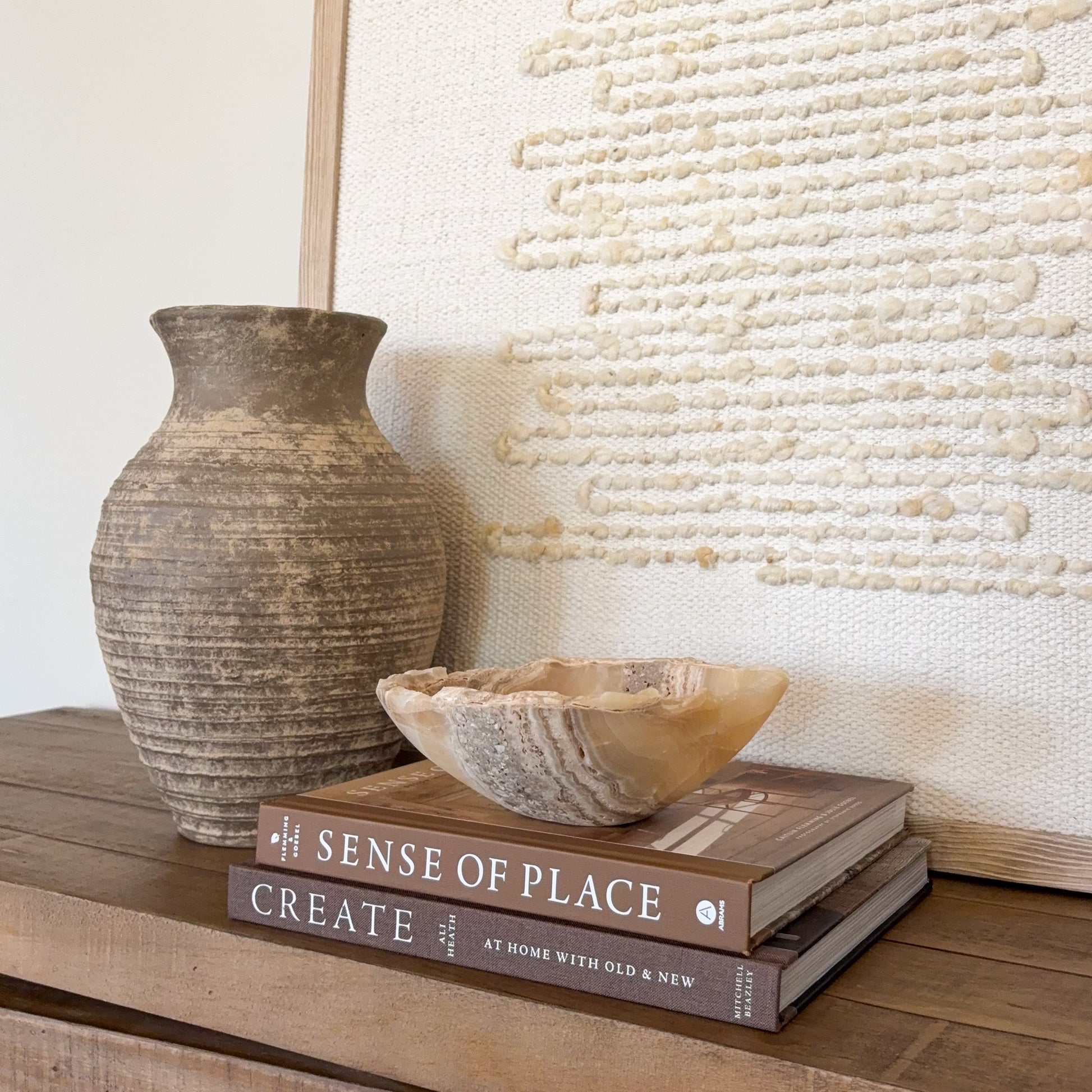 Small amber onyx bowl hand carved from natural stone with warm honey and cream banding