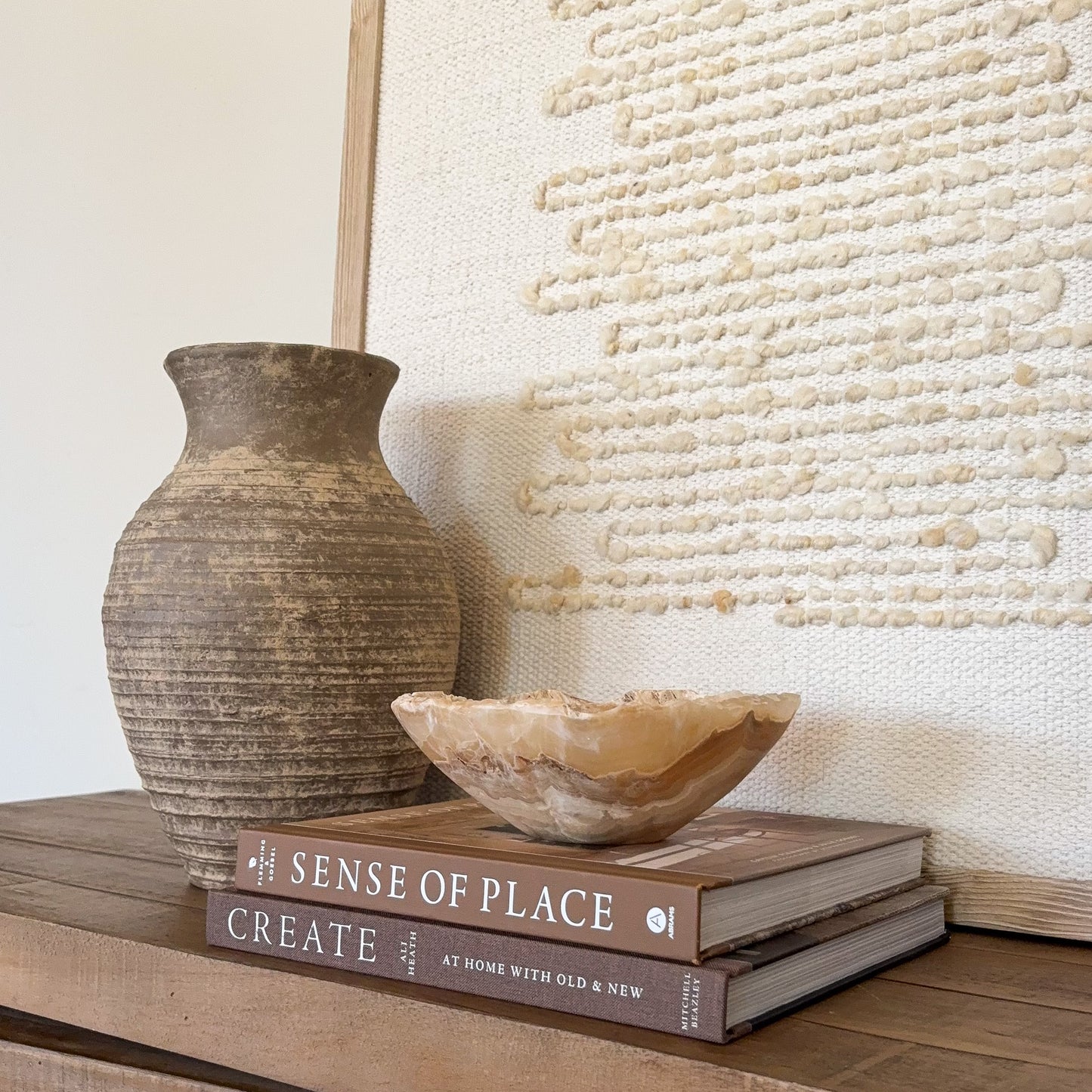 Polished small onyx crystal bowl in amber tones for decorative tabletop display