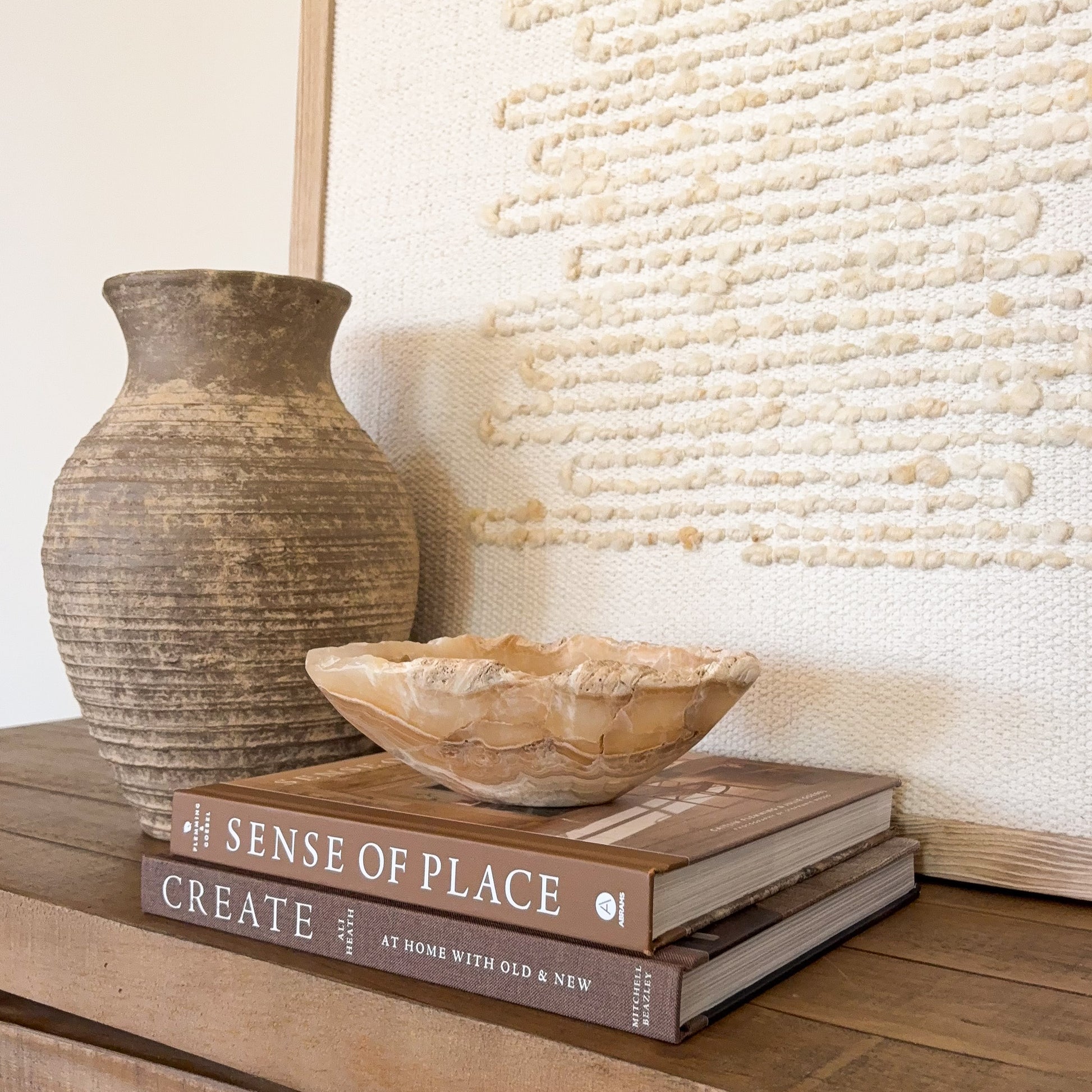 Small amber onyx bowl hand carved from natural stone with warm honey and cream banding