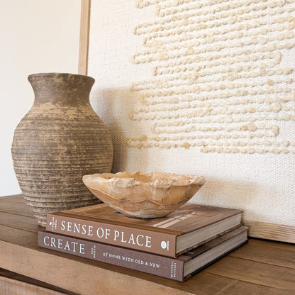 Small amber onyx bowl hand carved from natural stone with warm honey and cream banding