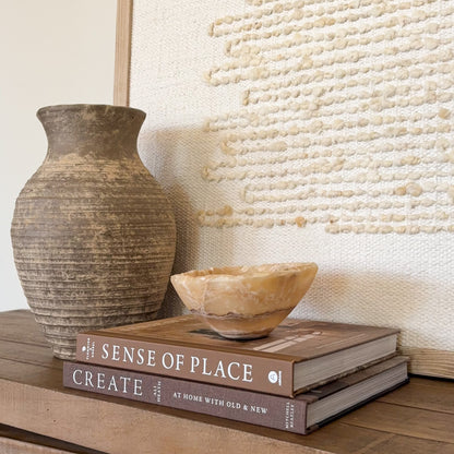 Small luxury onyx bowl carved from natural amber stone for shelf styling