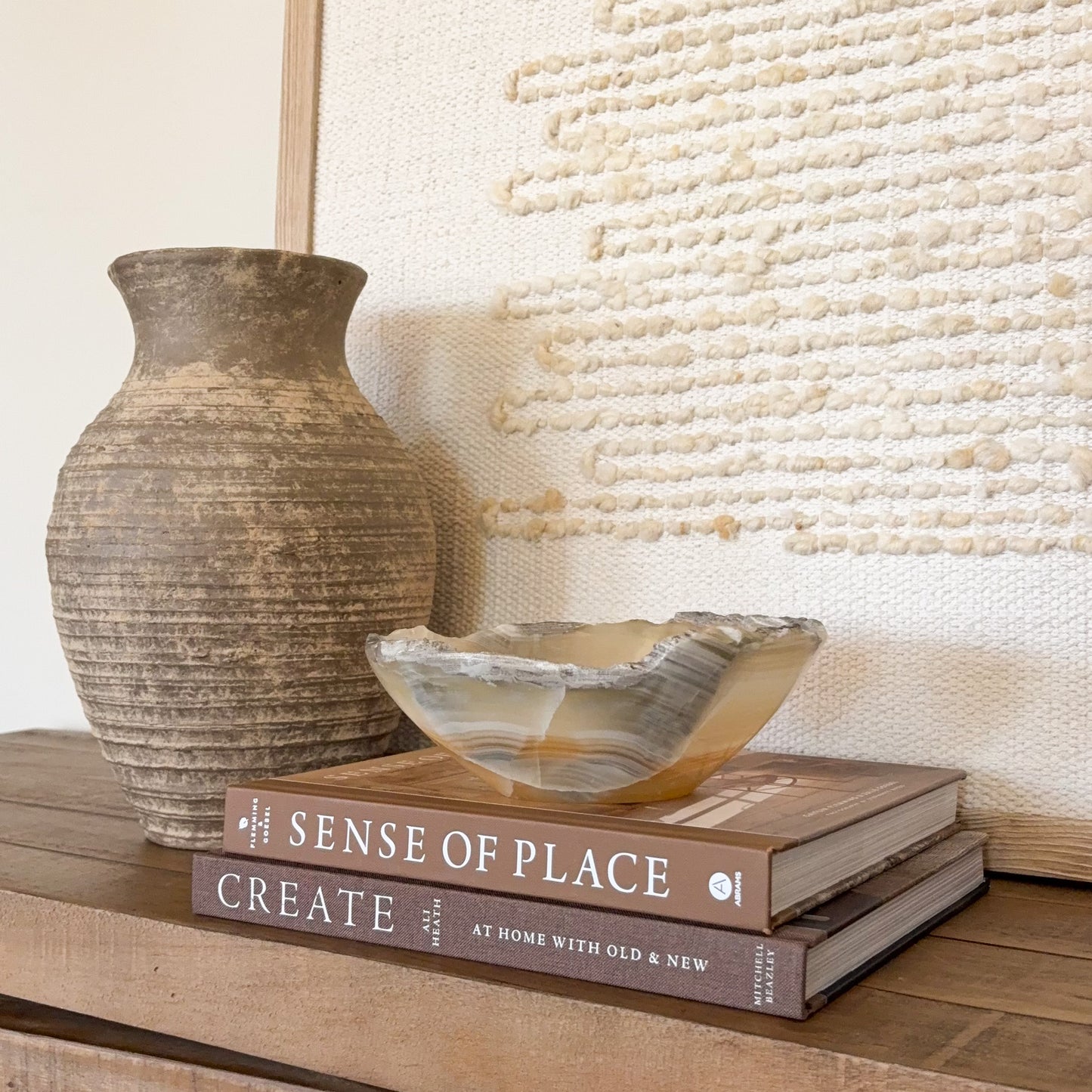 Polished small onyx crystal bowl in amber tones for decorative tabletop display