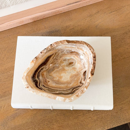 Hand carved amber onyx bowl featuring layered cream, gold, and gray banding, polished natural stone accent for modern home decor