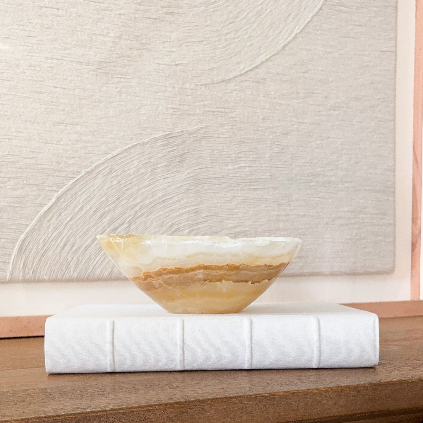 Small hand carved amber onyx bowl with natural stone veining, polished decorative gemstone dish