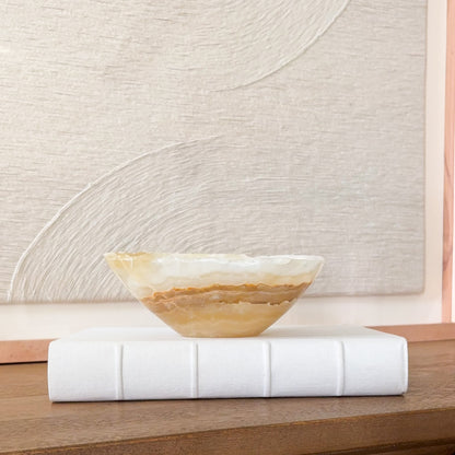 Small hand carved amber onyx bowl with natural stone veining, polished decorative gemstone dish