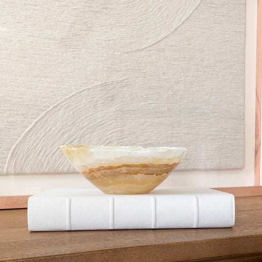 Small hand carved amber onyx bowl with natural stone veining, polished decorative gemstone dish