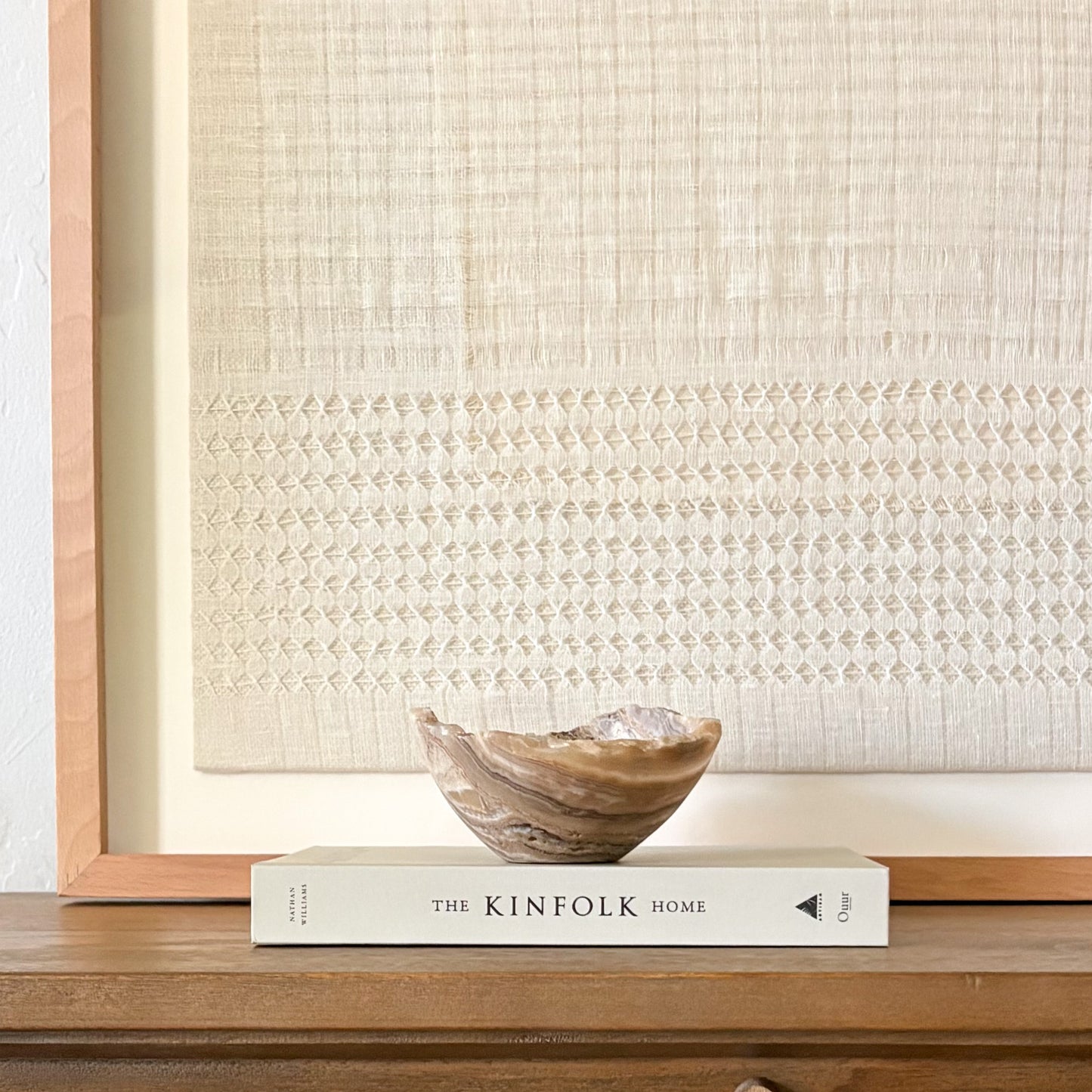 Small polished onyx bowl in amber tones, handcrafted decorative stone piece