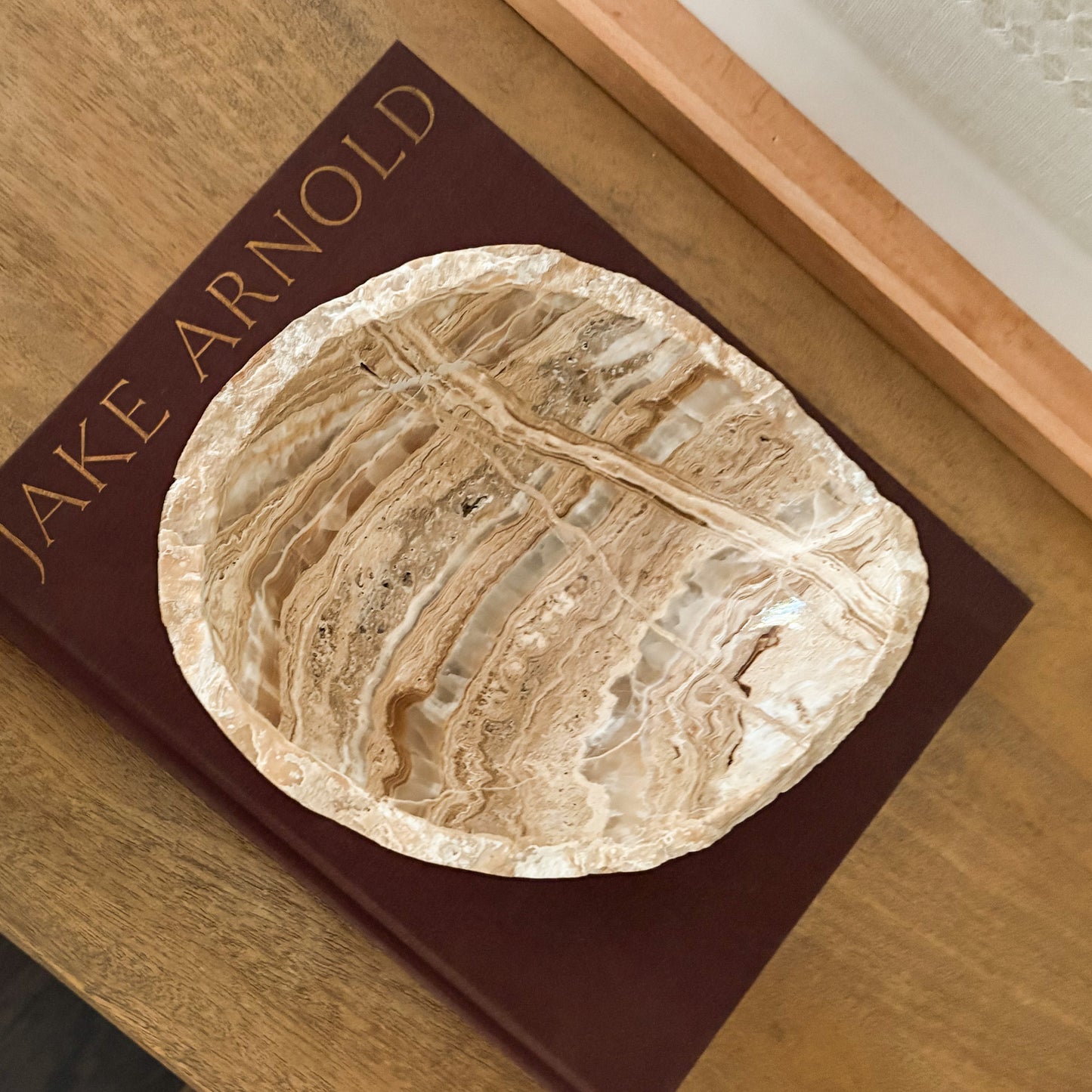 Decorative amber onyx bowl with unique natural veining for modern organic interiors