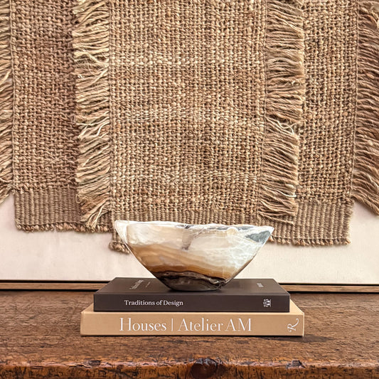 Hand-carved amber onyx decorative bowl with warm natural veining for luxury home décor.