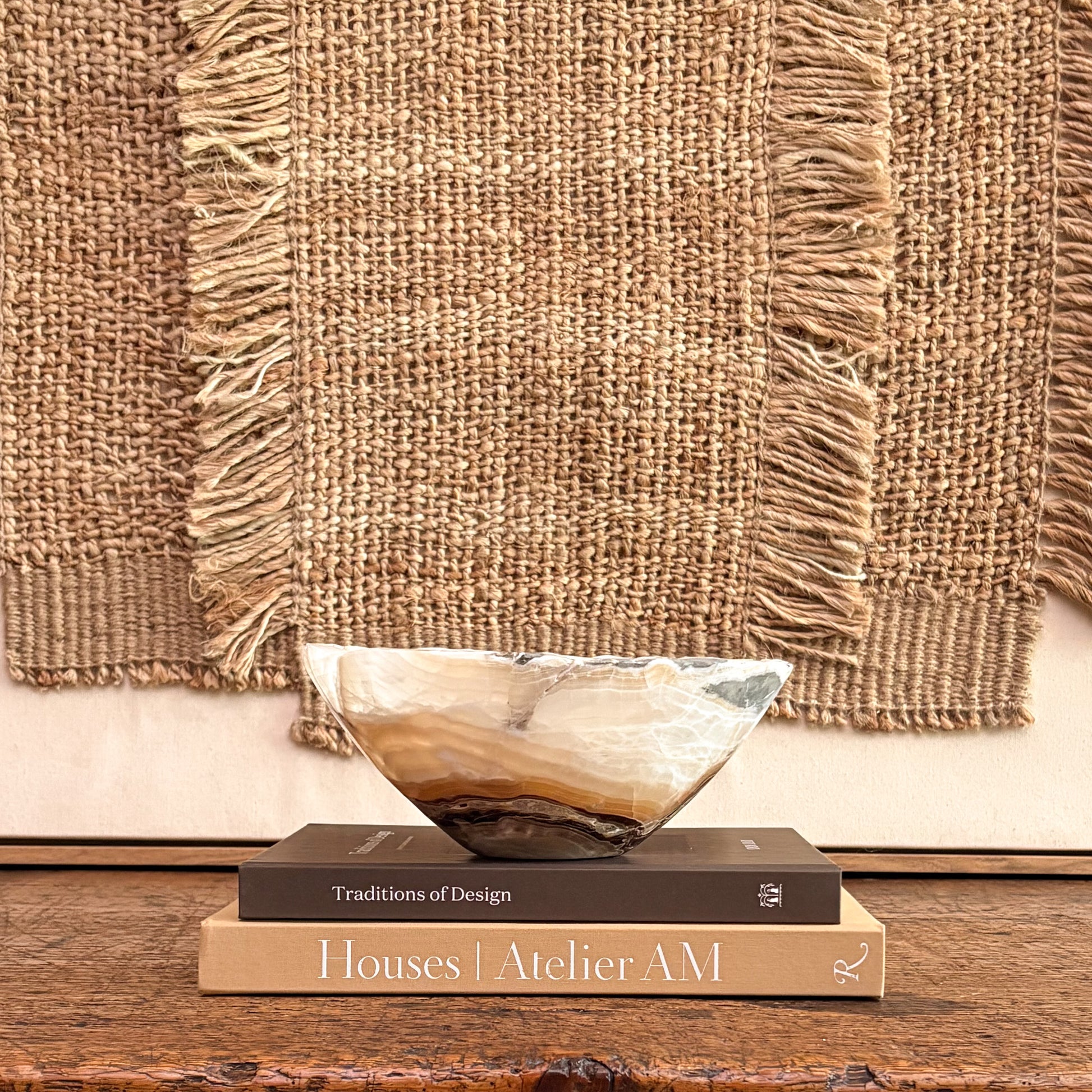 Artisan hand-carved amber onyx bowl showcasing unique natural stone patterns and rich golden hues.
