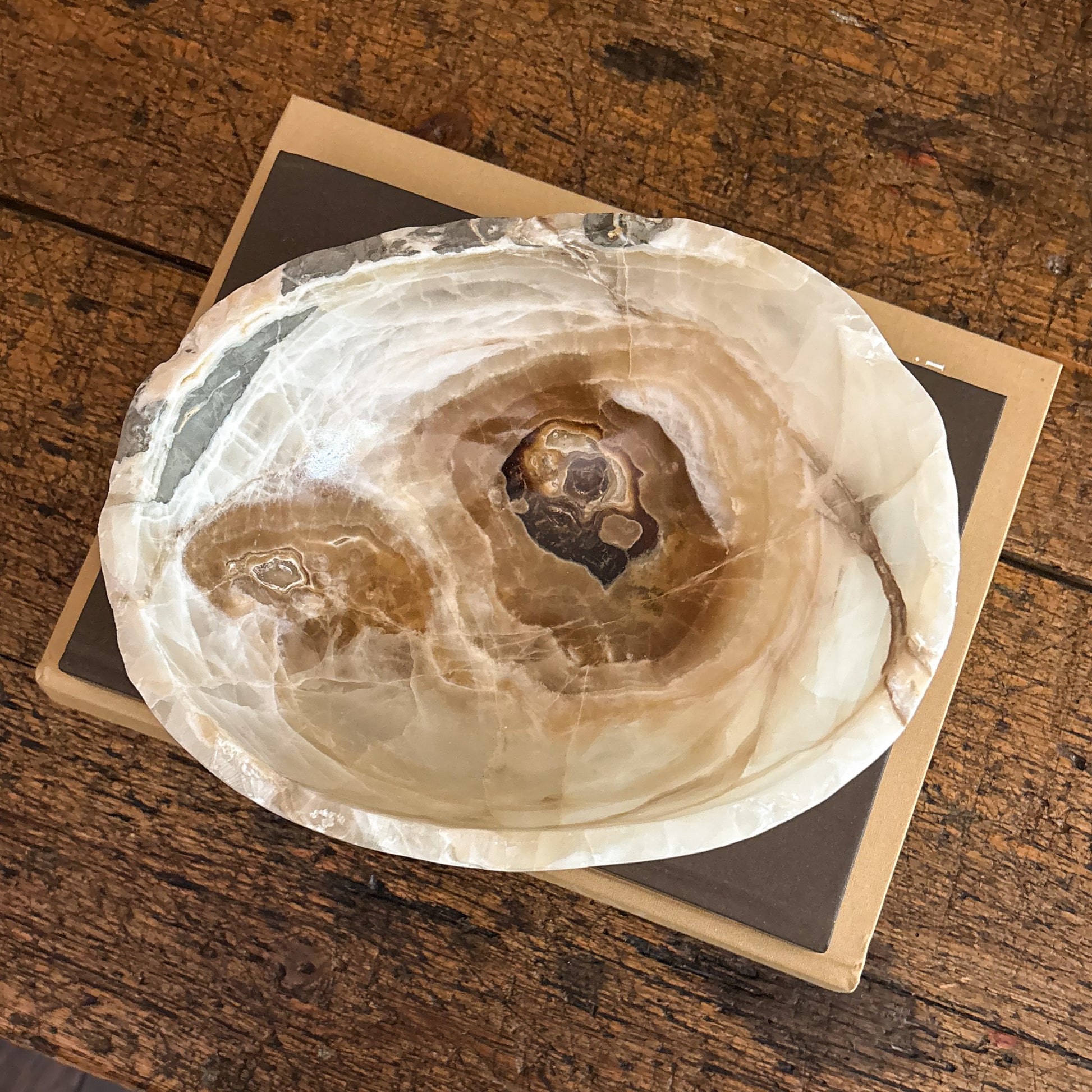 Decorative hand-carved amber onyx bowl with one-of-a-kind veining and polished finish.