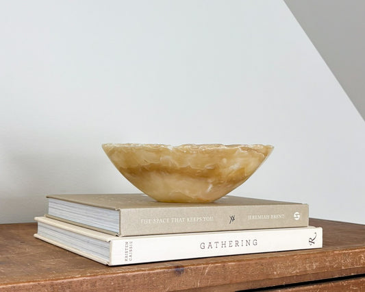 Small hand-carved amber onyx bowl with natural golden honey and cream veining