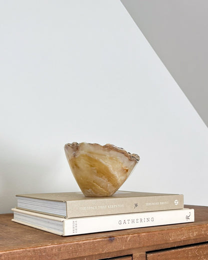 Small amber onyx stone bowl with natural translucent layers and unique veining