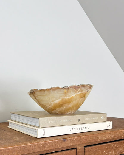 Hand-carved amber onyx catchall bowl in warm golden and caramel tones