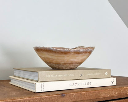 Small hand-carved amber onyx bowl with natural golden honey and cream veining