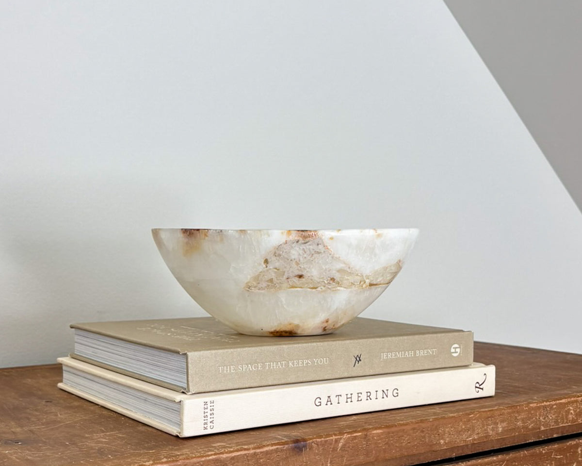 Small natural amber onyx bowl with intricate veining and polished stone finish