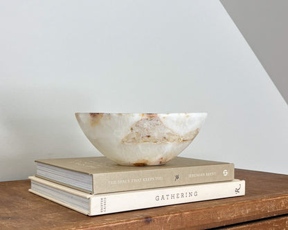 Small natural amber onyx bowl with intricate veining and polished stone finish