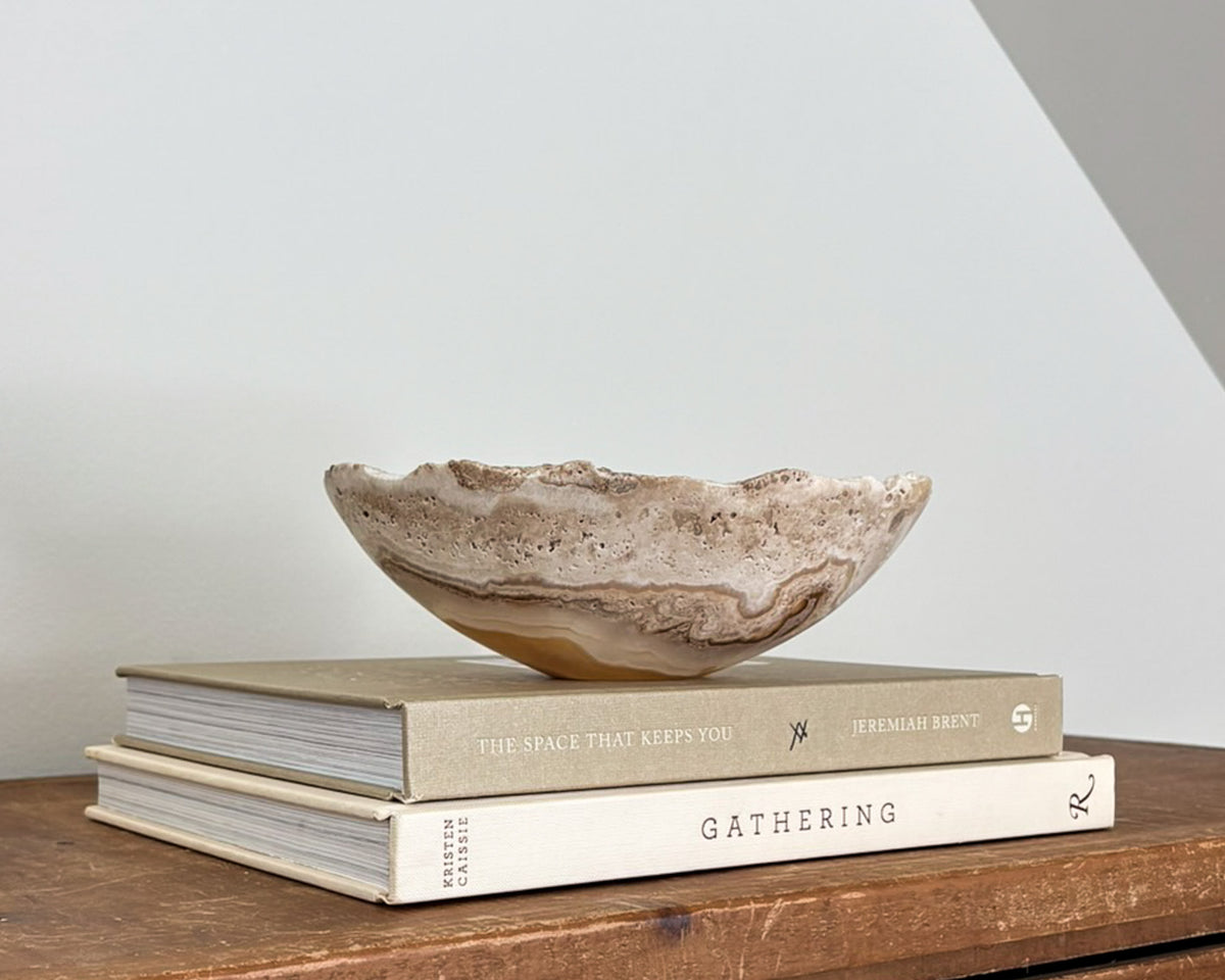 Hand-carved small amber onyx bowl with warm golden hues and distinctive natural banding