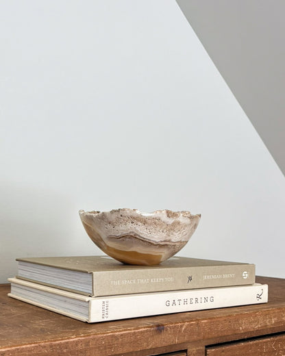 Small natural amber onyx bowl with intricate veining and polished stone finish