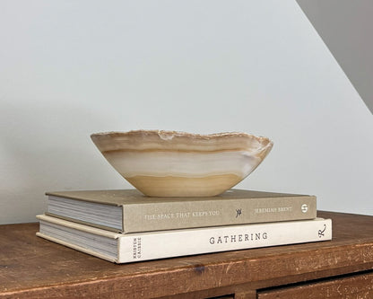 Hand-carved amber onyx catchall bowl in warm golden and caramel tones