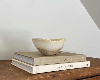 Small natural amber onyx bowl with intricate veining and polished stone finish