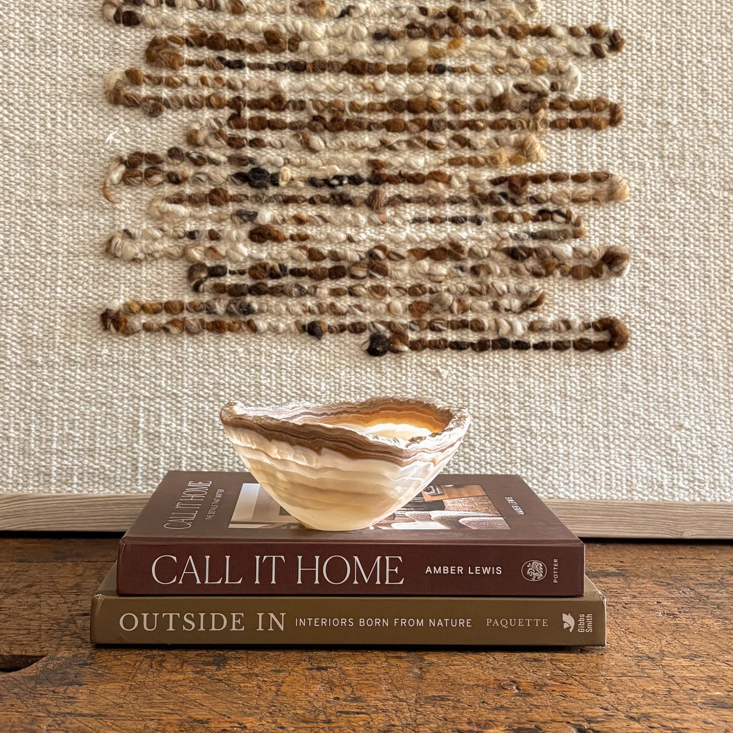 Hand carved amber onyx bowl featuring warm honey and cream stone layers, artisan decorative dish