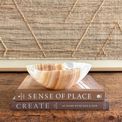 Hand-carved amber onyx bowl with warm honey bands, polished interior