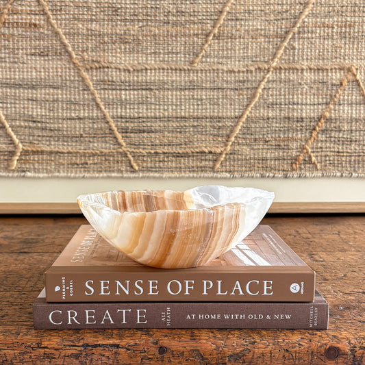 Hand-carved amber onyx bowl with warm honey bands, polished interior