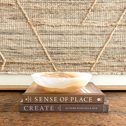 Hand-carved amber onyx bowl with warm honey bands, polished interior
