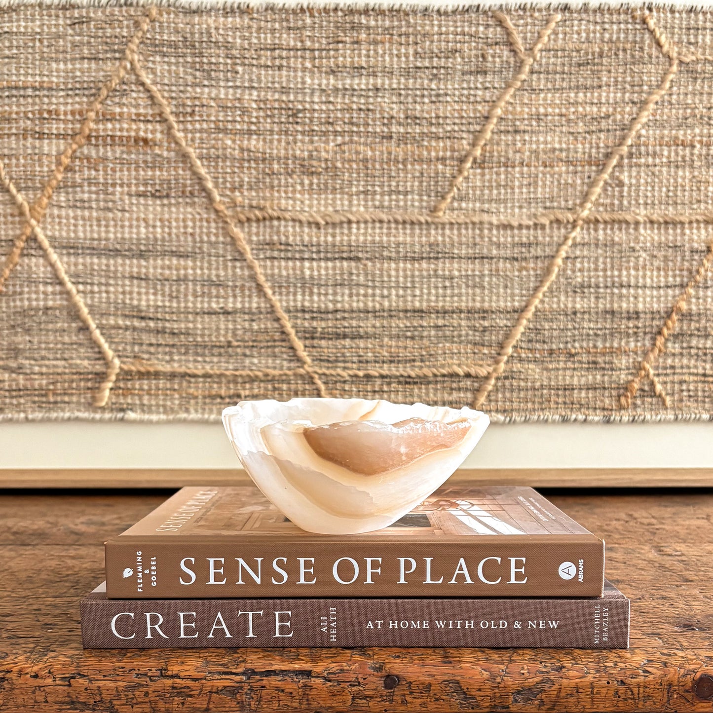 Handcrafted amber onyx stone bowl, glowing light through layered veins