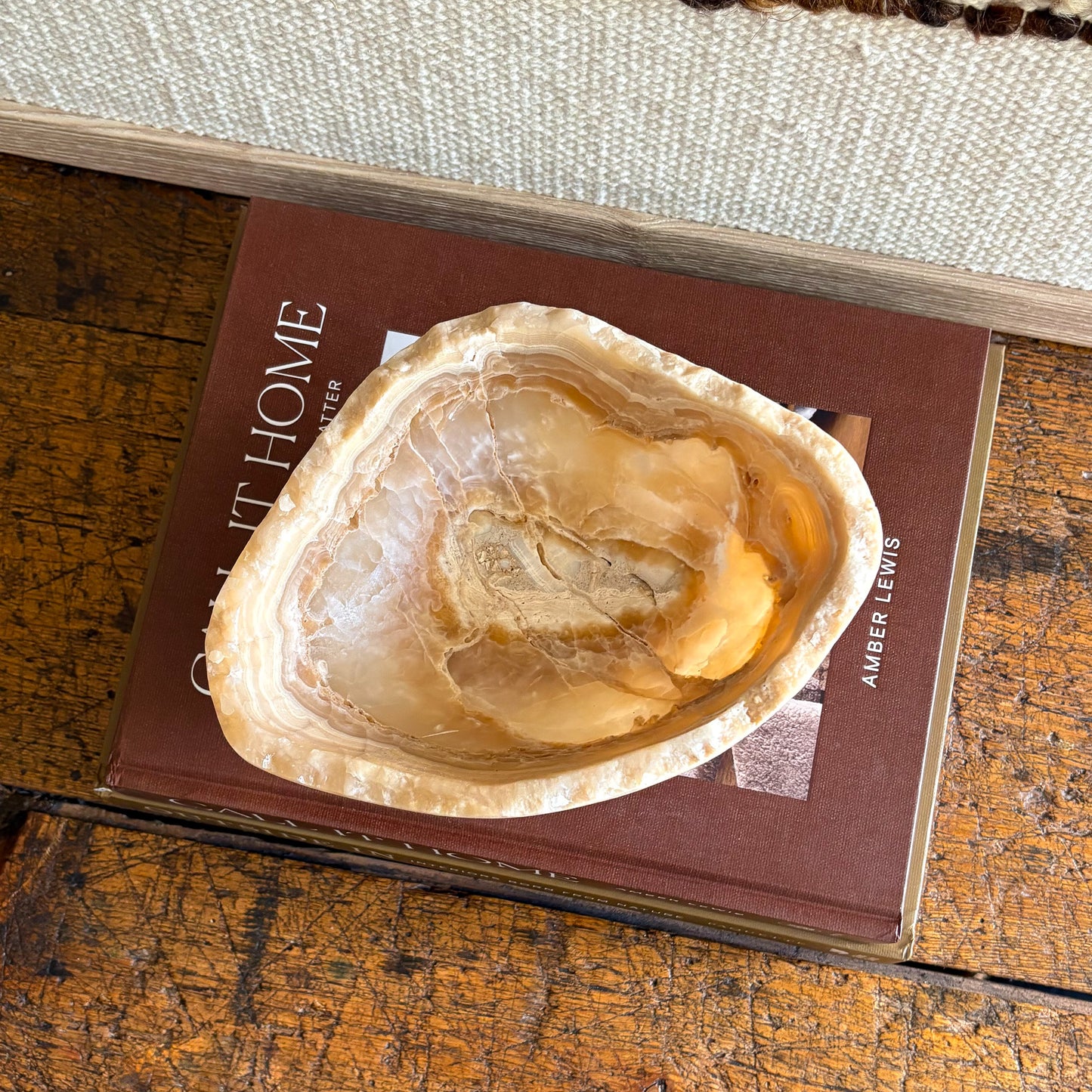 Handcrafted amber onyx stone bowl, glowing light through layered veins