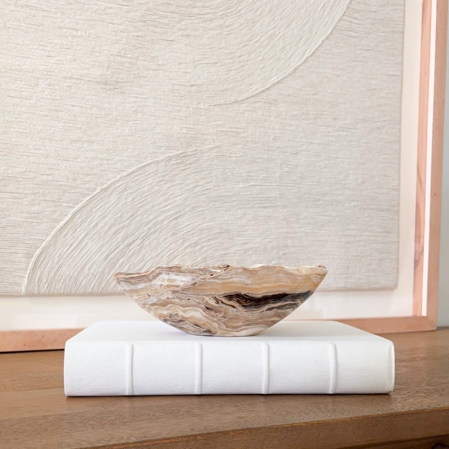 Small hand carved amber onyx bowl, natural banded stone dish in warm beige and golden hues for jewelry or decorative display