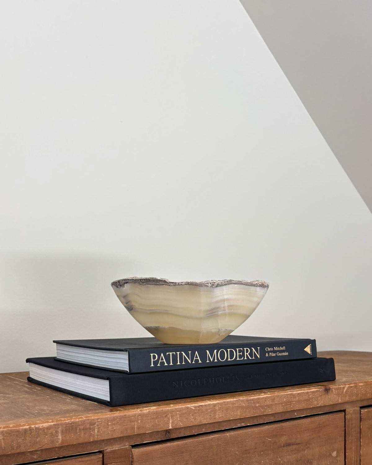 Decorative grey onyx bowl styled on a console table in a modern interior