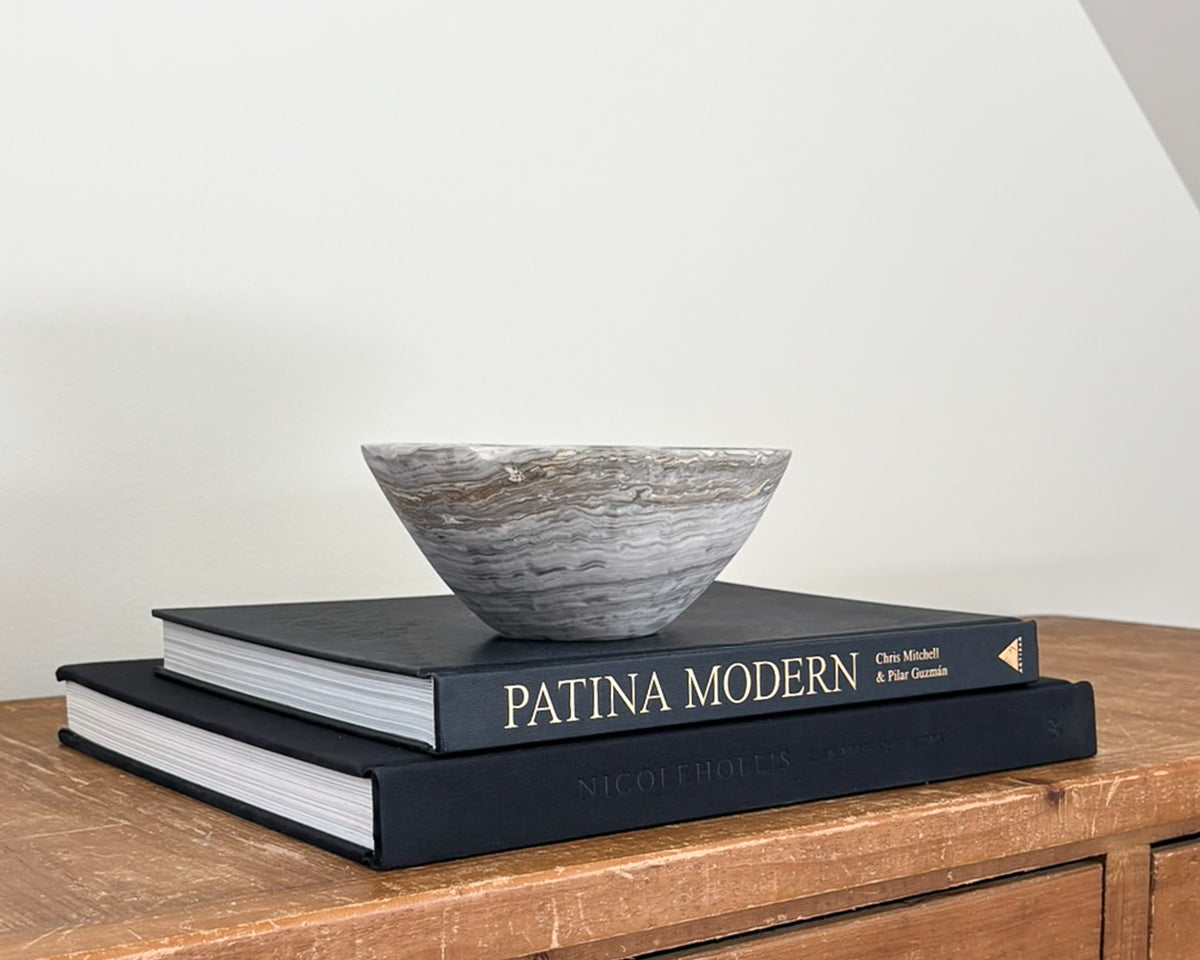Polished grey onyx bowl featuring unique mineral patterns and tonal variations