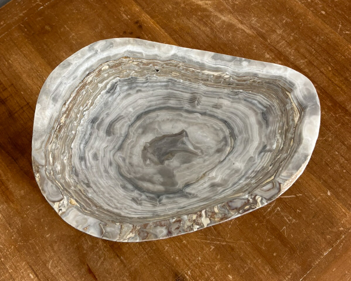 Artisan-carved grey onyx bowl with distinctive natural banding