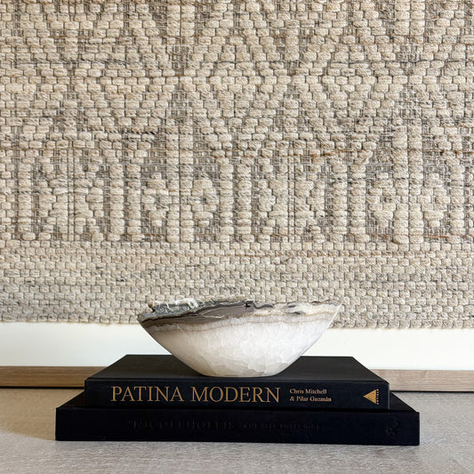 Hand carved stone bowl styled in a neutral, textured interior setting