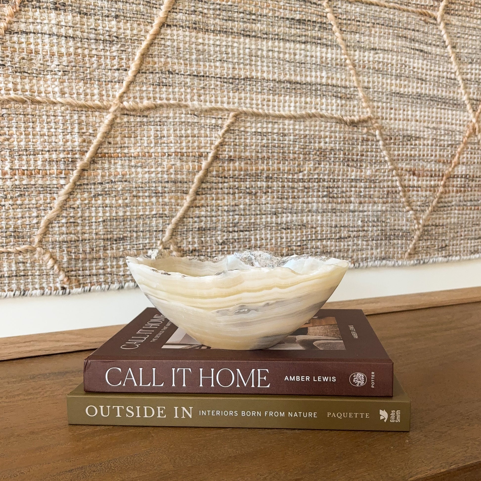 Small amber onyx stone bowl with smooth polished interior and layered cream, honey, and gray veining, handcrafted decorative bowl