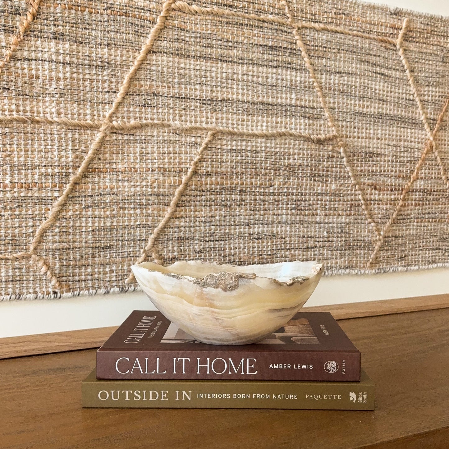 Small hand carved amber onyx bowl with natural banded stone veining in warm honey and cream tones, decorative gemstone dish