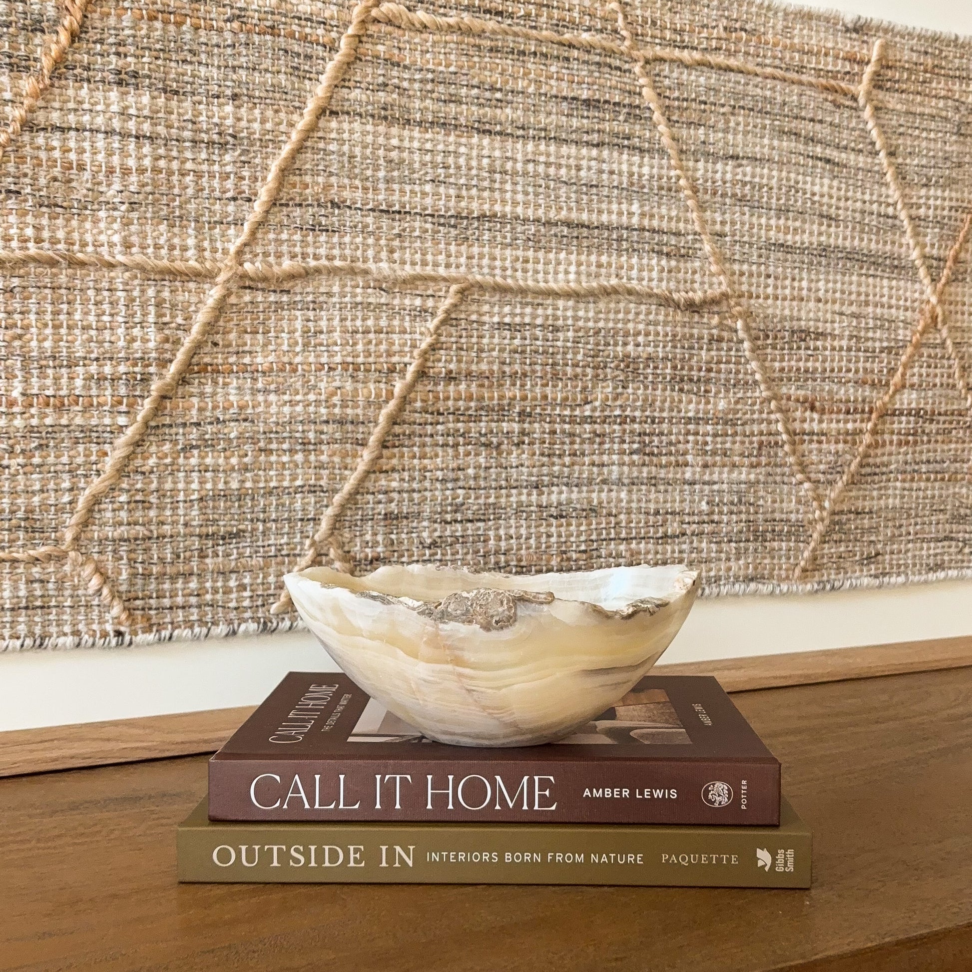 Small hand carved amber onyx bowl with natural banded stone veining in warm honey and cream tones, decorative gemstone dish