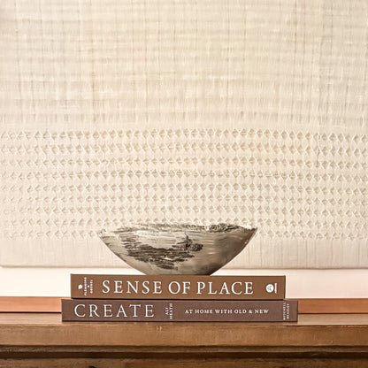 Sculptural grey onyx bowl showcasing unique veining and hand-carved craftsmanship.