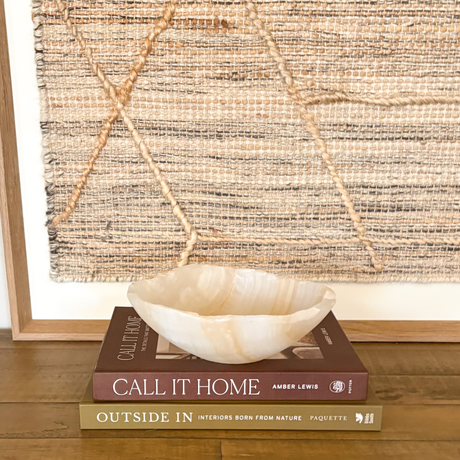 Small polished amber onyx bowl styled on coffee table books