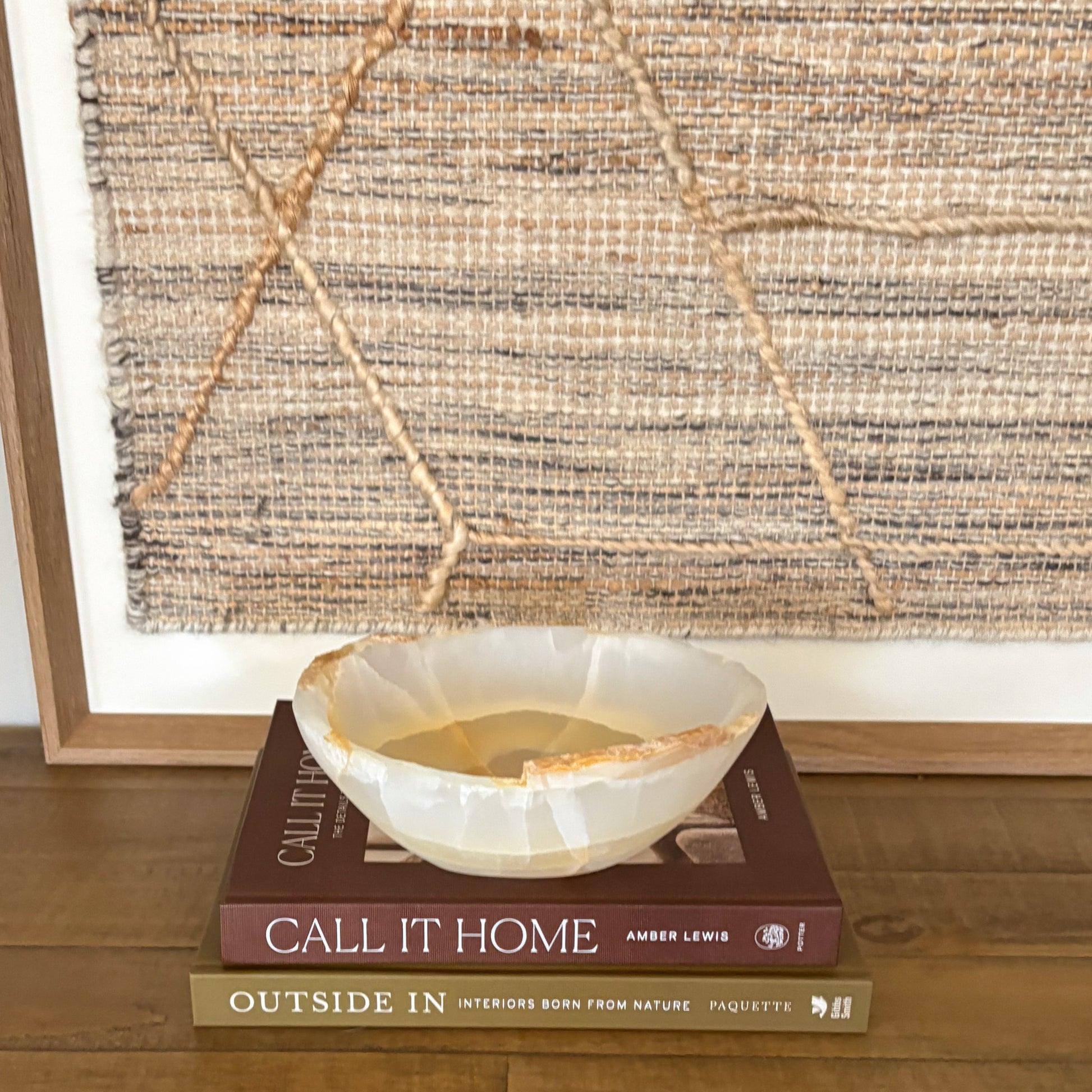 Small polished amber onyx bowl styled on coffee table books