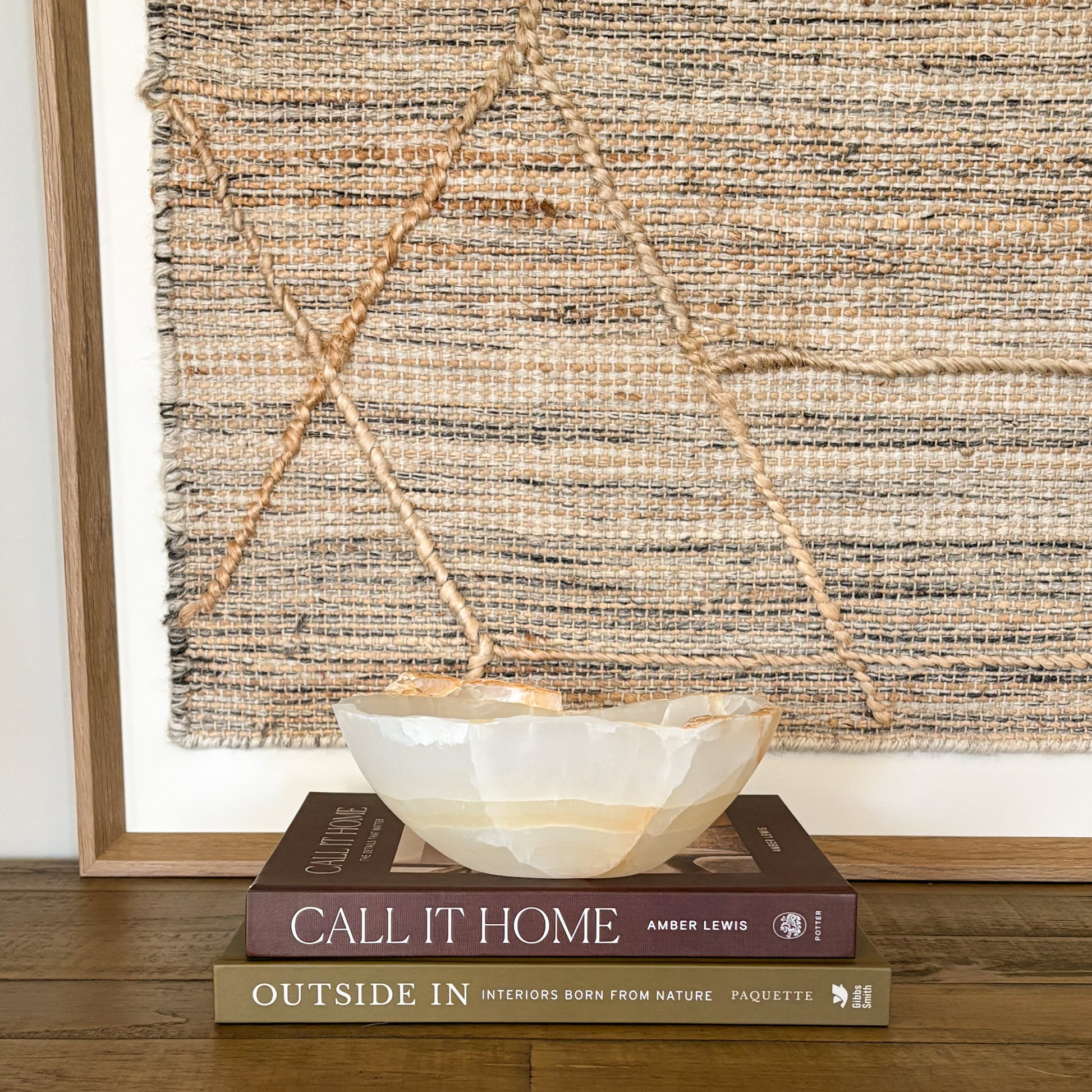 Small amber onyx bowl styled on wooden surface with neutral wall art