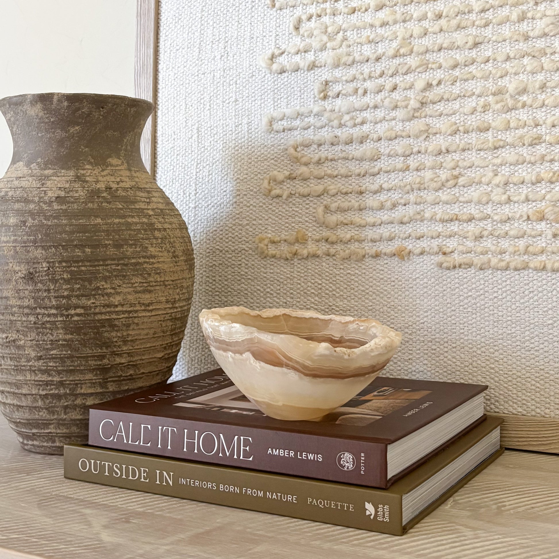 Small polished amber onyx bowl styled on coffee table books