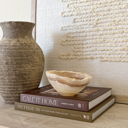Small polished amber onyx bowl styled on coffee table books