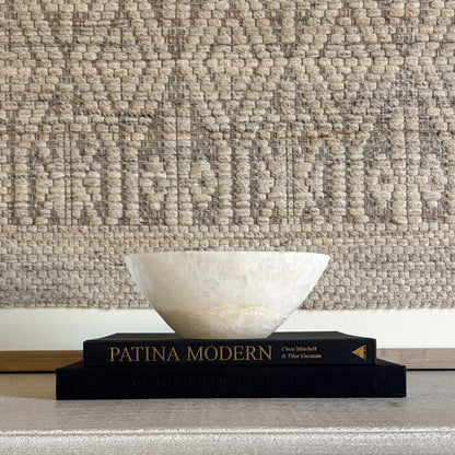 Hand-carved white onyx bowl showcasing natural veining and polished stone finish