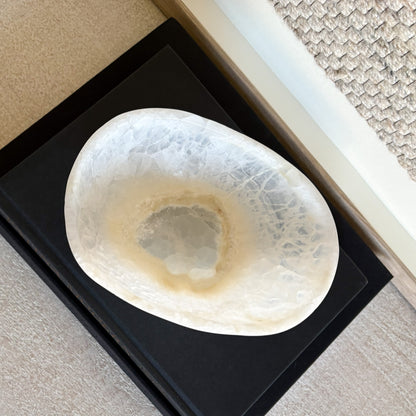 Close-up of natural white onyx stone bowl highlighting translucent texture and artisan craftsmanship