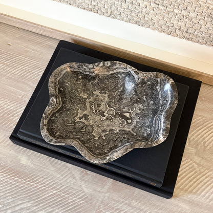Small hand-carved zebra onyx bowl used as decorative stone accent