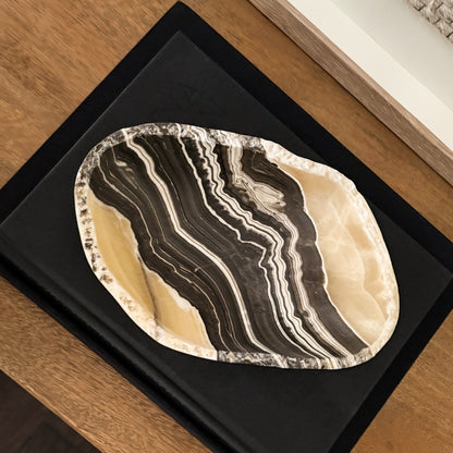 Decorative hand-carved grey onyx centerpiece bowl with natural stone variations.